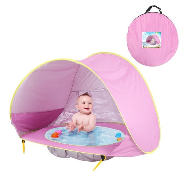Safe baby beach shade tent, offering UV protection and a small pool for water play.