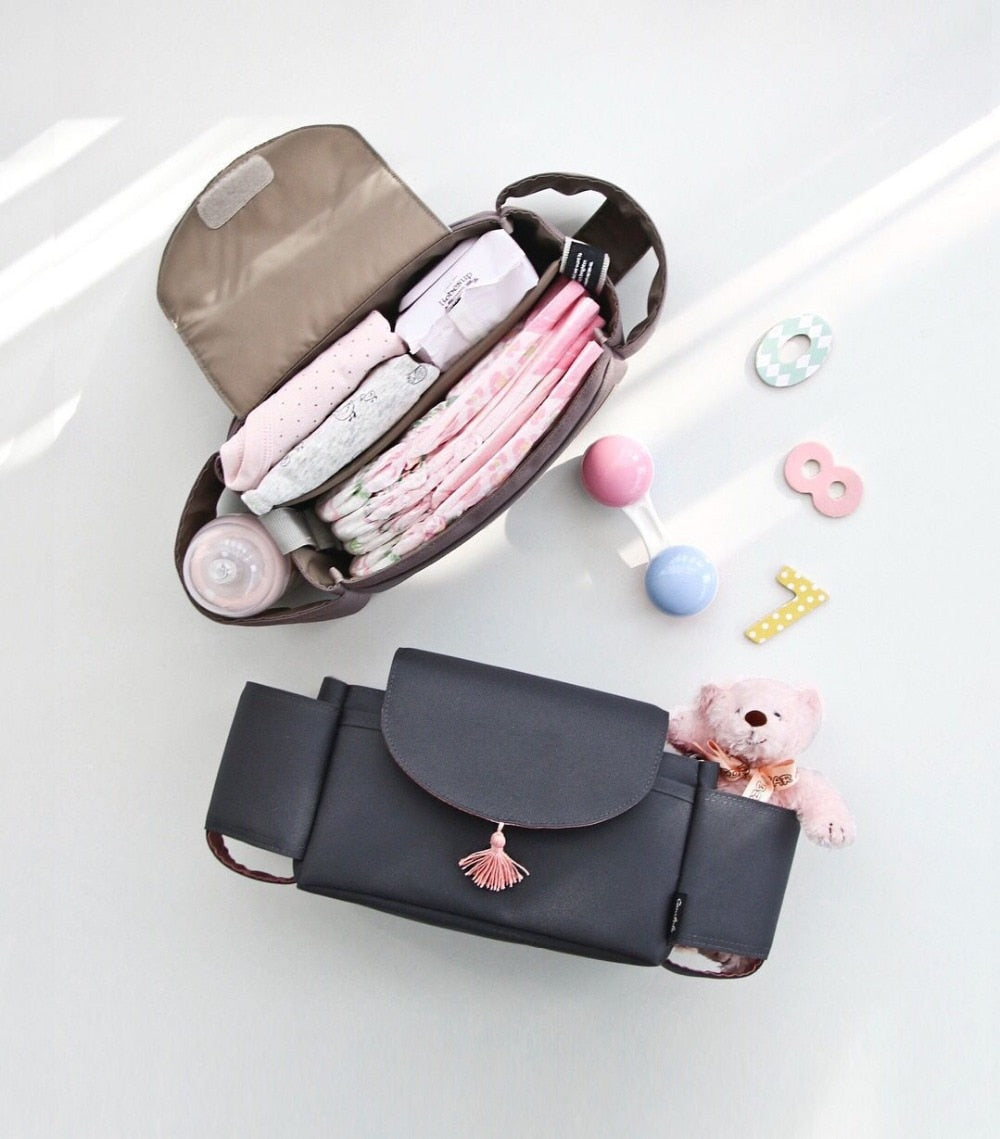 Portable stroller bag & parent organizer, waterproof and featuring adjustable compartments for baby items.