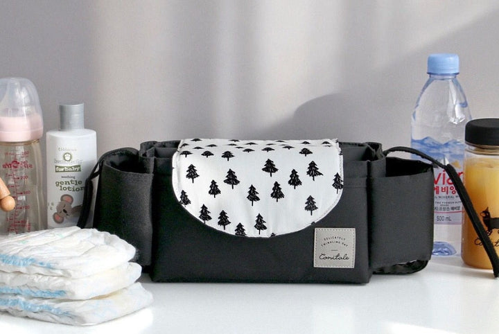 Waterproof parent organizer attached to a stroller, keeping diapers, bottles, and wipes easily accessible.