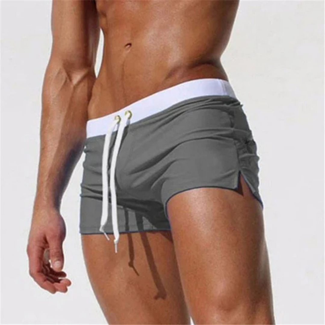 Comfortable quick-dry men's swim shorts with drawstring, essential for summer & resort wear.