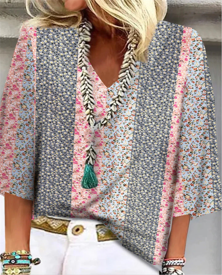 Women's chic floral print blouse with relaxed fit, V-neck, & 3/4 sleeves. Perfect for spring/summer casual wear.
