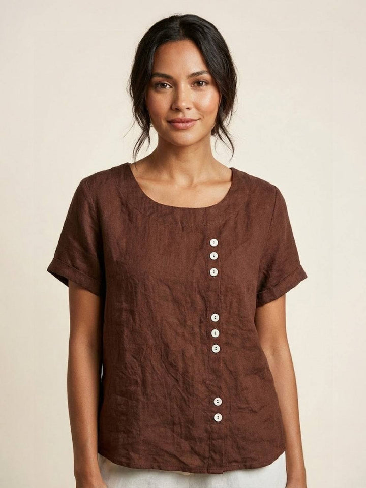 Relaxed fit short sleeve women's top with a flattering scoop neck and button detailing.