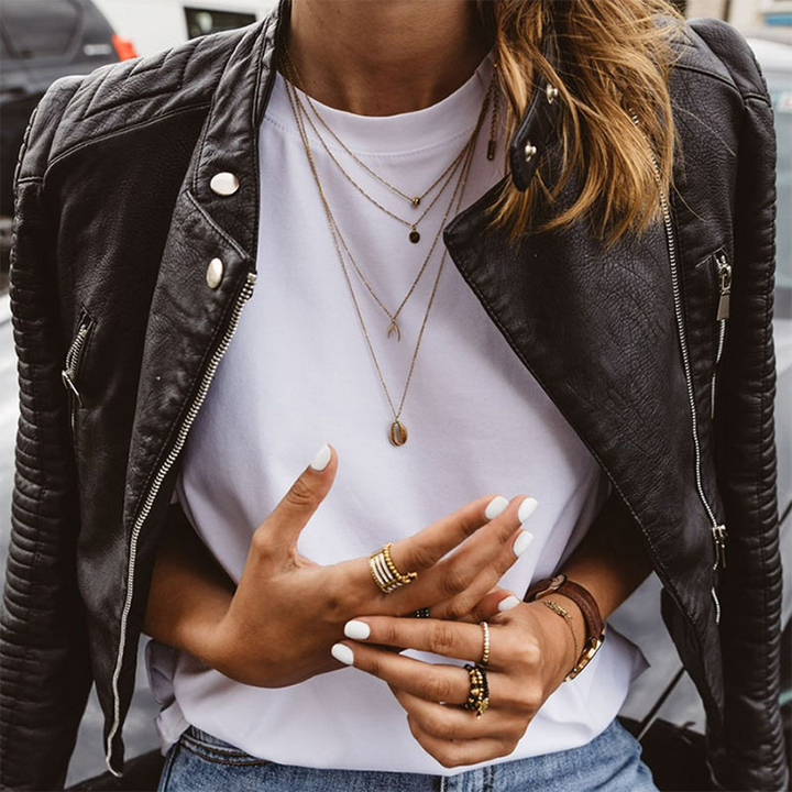 Fitted women's biker jacket, black with stylish ribbed sleeves. A chic outerwear piece for casual or edgy looks.