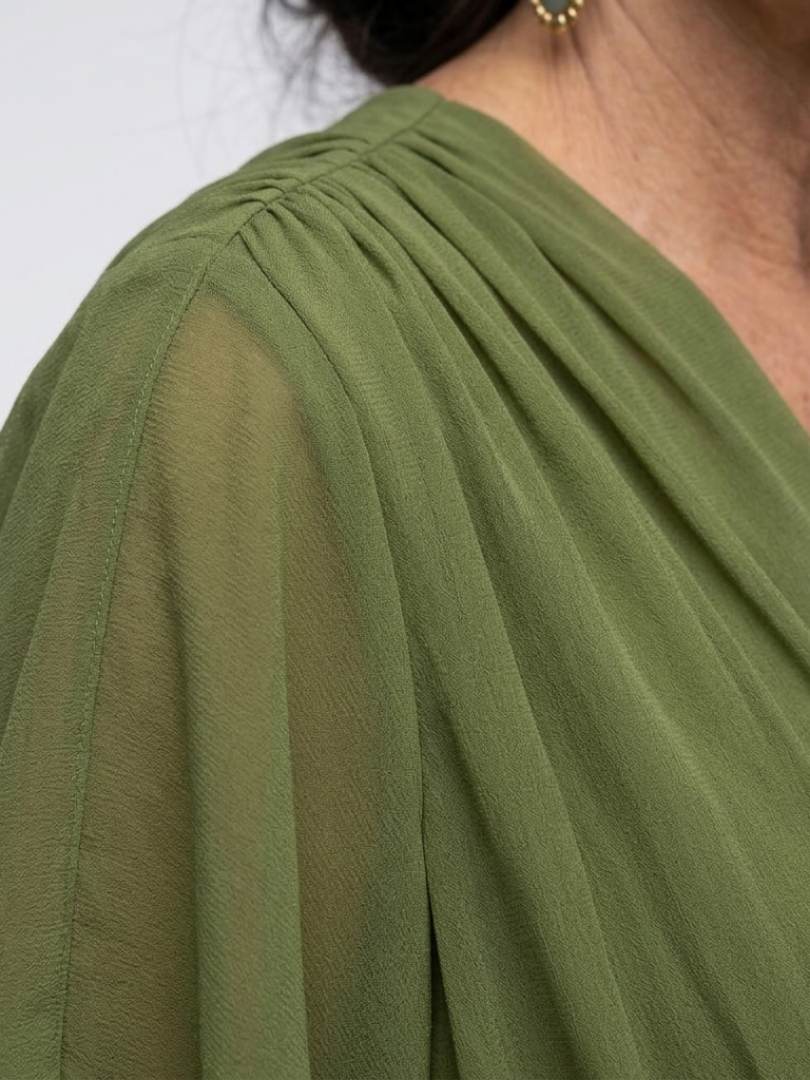 Close-up of a flattering women's midi dress featuring stylish draped detail and adjustable waist tie.