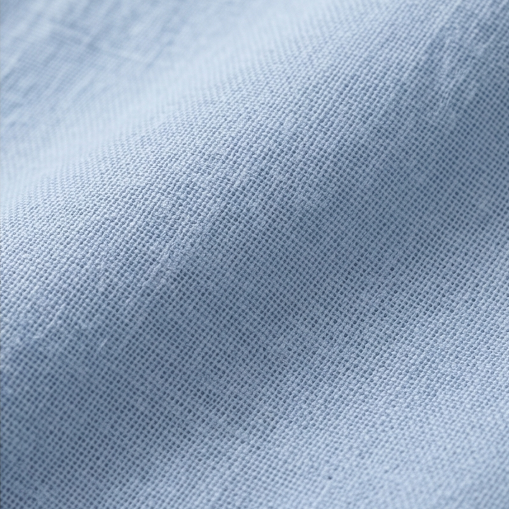 Light blue women's relaxed fit top with a Henley placket, great for casual summer outings.