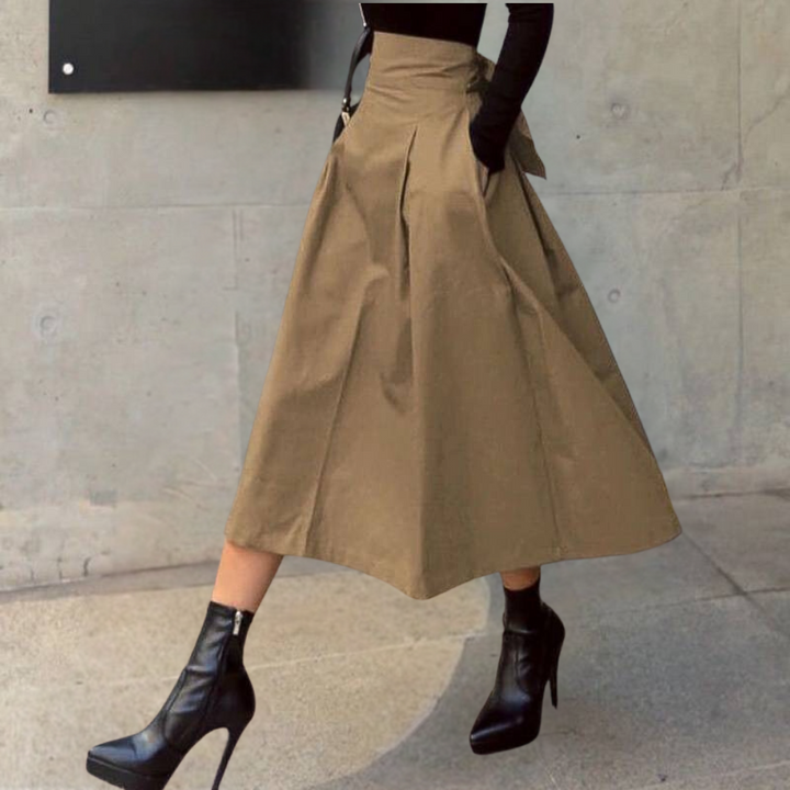 Stylish women's black pleated A-line midi skirt with a high waist, suitable for professional or casual wear.