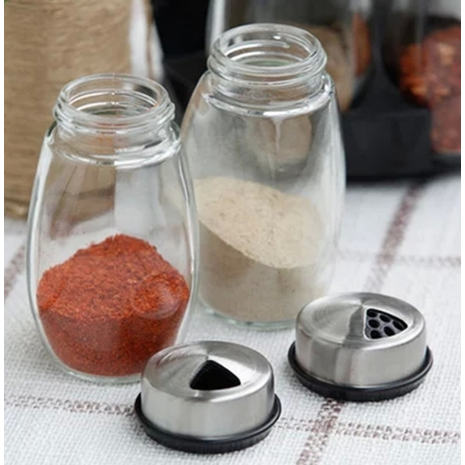 Modern rotating spice rack with six empty glass jars, a compact kitchen organizer for herbs & spices.