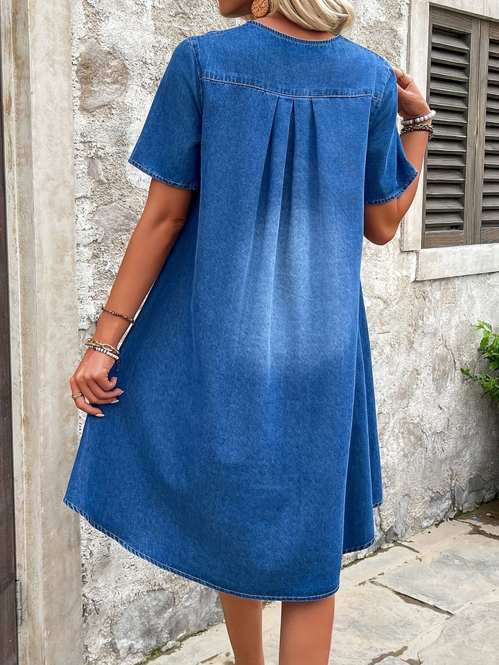 Woman modeling a relaxed fit blue short sleeve midi dress, perfect for comfortable summer casual fashion.