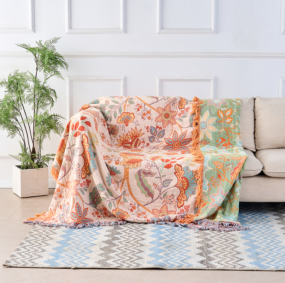 Vibrant floral pattern on a soft cotton throw blanket. Ideal for boho or rustic home decor accents.