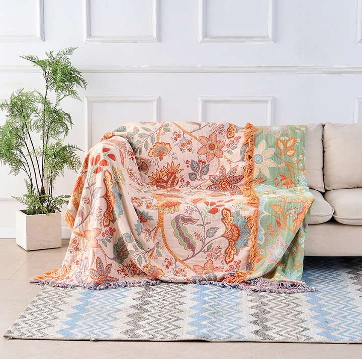 Vibrant floral pattern on a soft cotton throw blanket. Ideal for boho or rustic home decor accents.