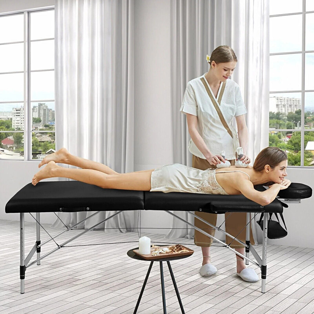 Portable aluminum massage table, professional & adjustable height, ideal for therapists.