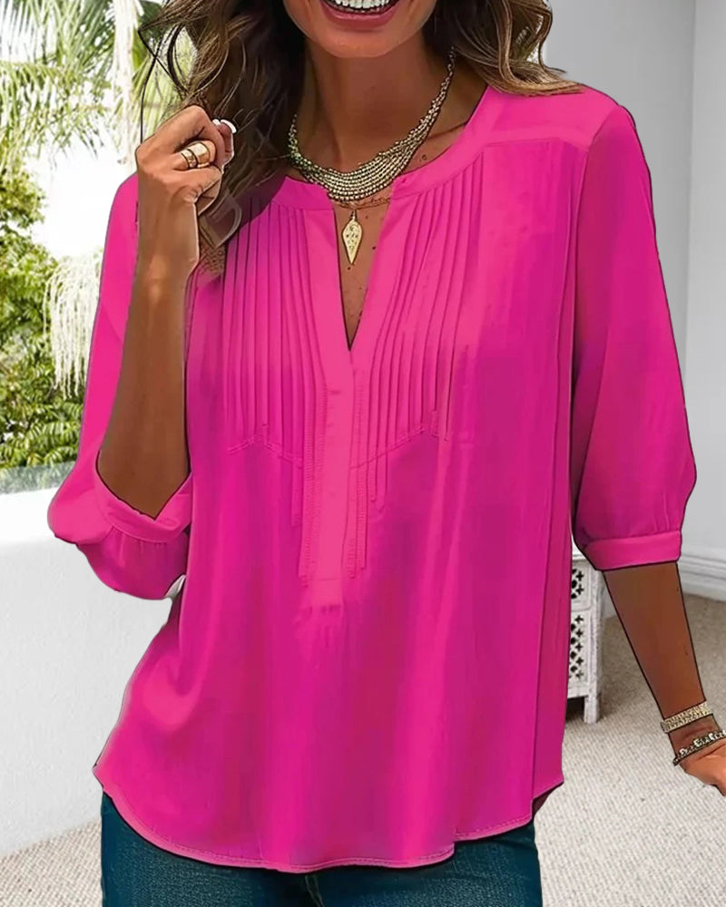 Elegant women's pleated tunic top with a flattering split neck & three-quarter sleeves for chic comfort.