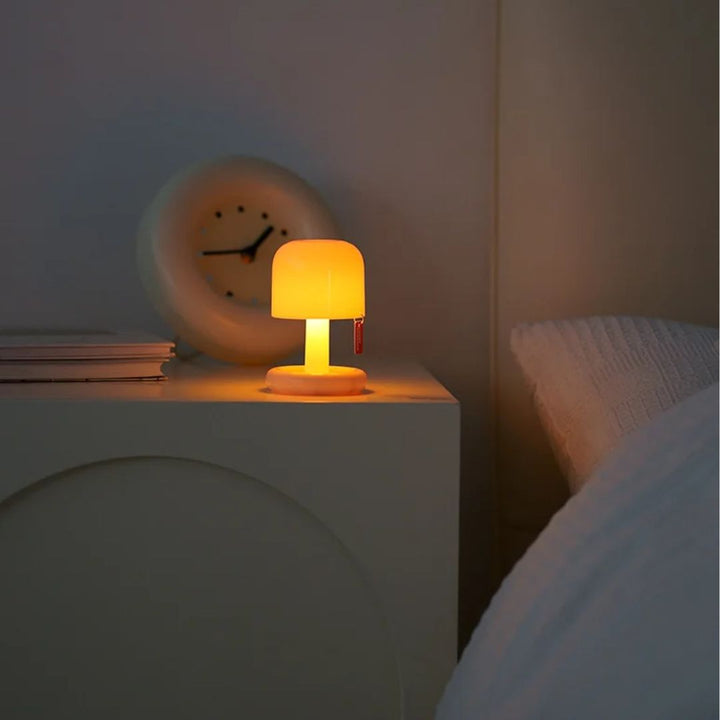 Compact sunset projector light illuminating a bedroom with a calming, ambient glow.