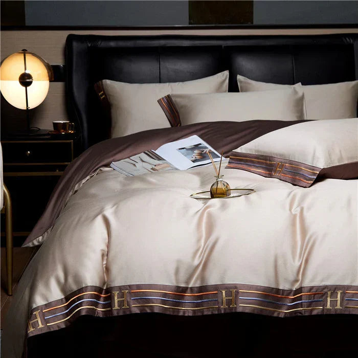 Satin cotton embroidered duvet cover set, soft & luxurious. Enhances bedroom decor with all-season comfort.