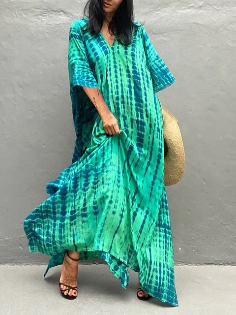 Women's elegant tie-dye kaftan maxi dress, flowing bohemian beach and resort wear.
