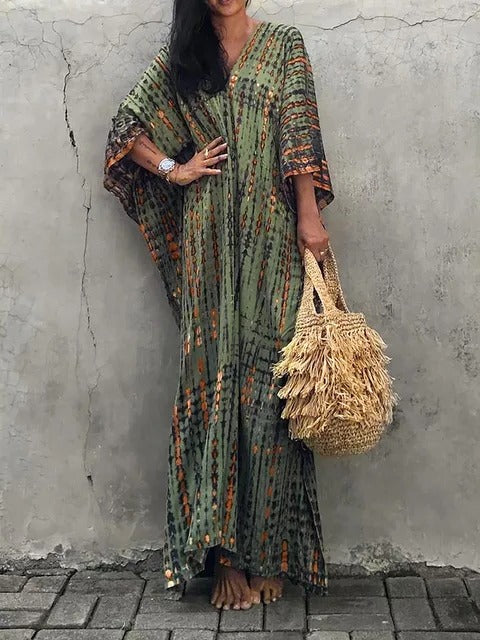 Detail shot of the flattering V-neck on a women's tie-dye kaftan maxi dress.