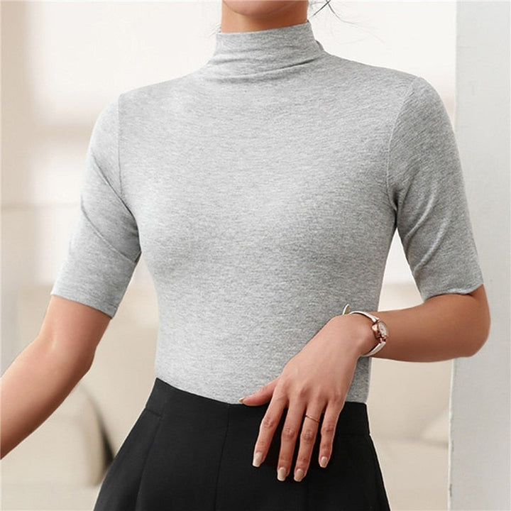 Basic women's seamless roll neck top, an essential for layering or a chic standalone, providing comfort & style.