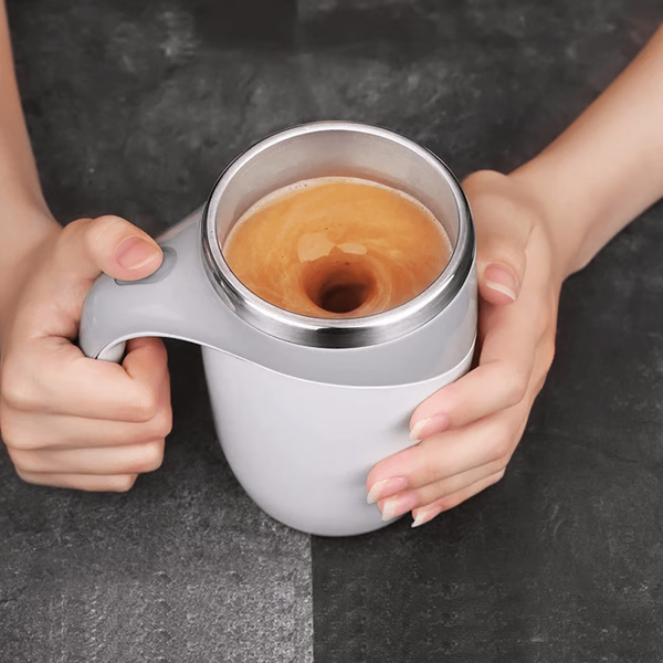 Rechargeable self-stirring coffee mug with lid, perfect for mixing hot beverages like coffee or tea on the go.