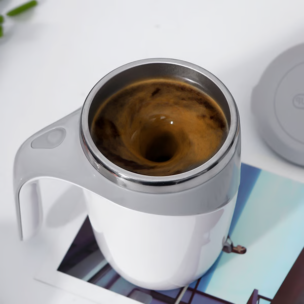 Sleek stainless steel self-stirring mug with lid, rechargeable automatic mixer for coffee and hot drinks.