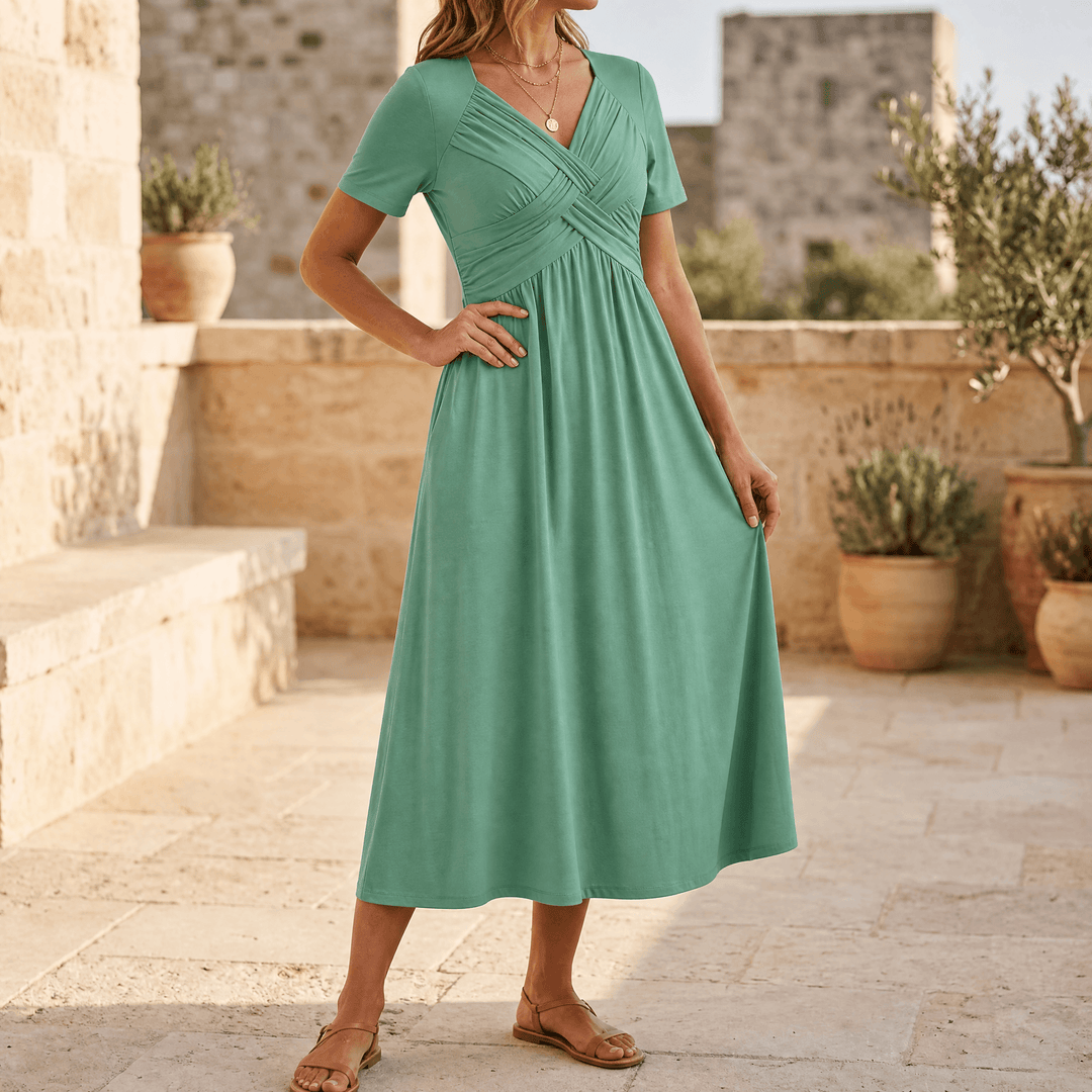 Full-length view of a women's crossover V-neck midi dress, showcasing its flattering A-line cut and practical pockets.