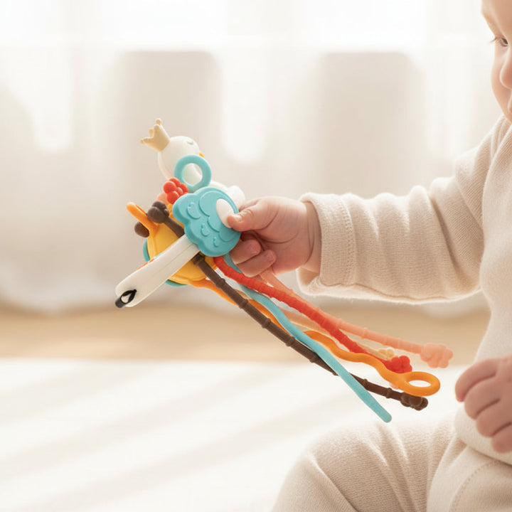 Baby teething & fine motor toy with soft buttons & textured cords. Develops sensory skills & early learning for infants.