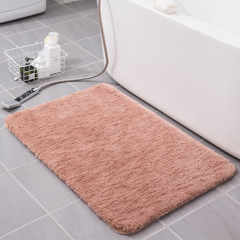 Absorbent shaggy microfiber shower mat, quick-dry and non-slip, essential bathroom accessory.