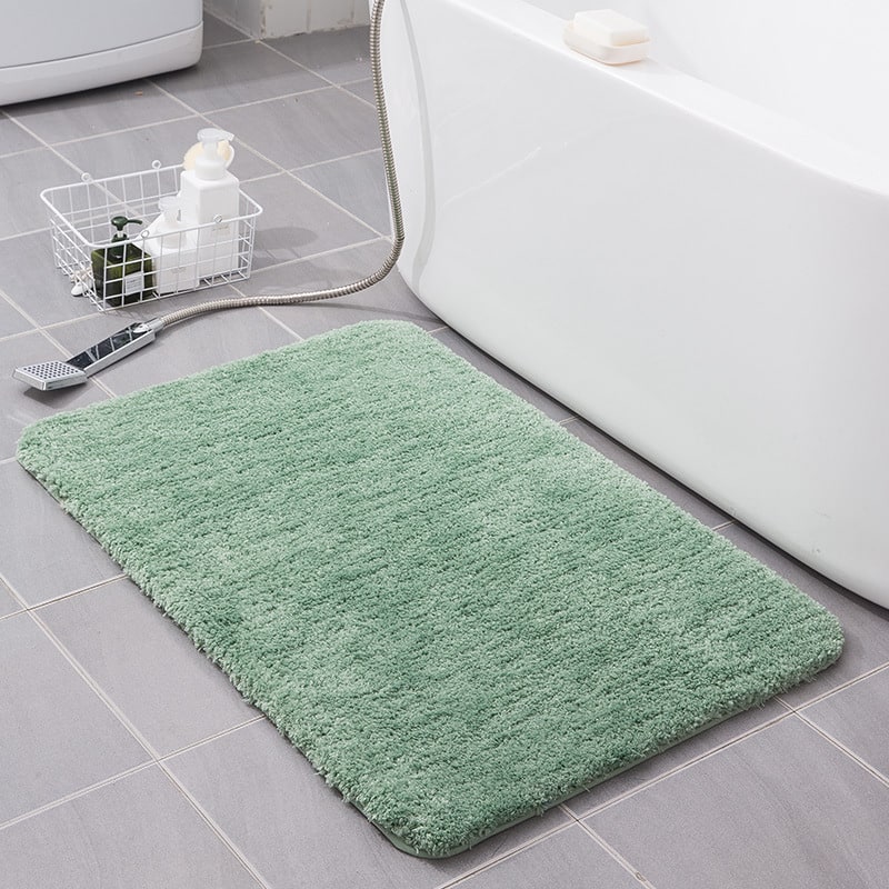 Elegant shaggy bath mat, quick-dry microfiber, non-slip base, enhances bathroom home decor.