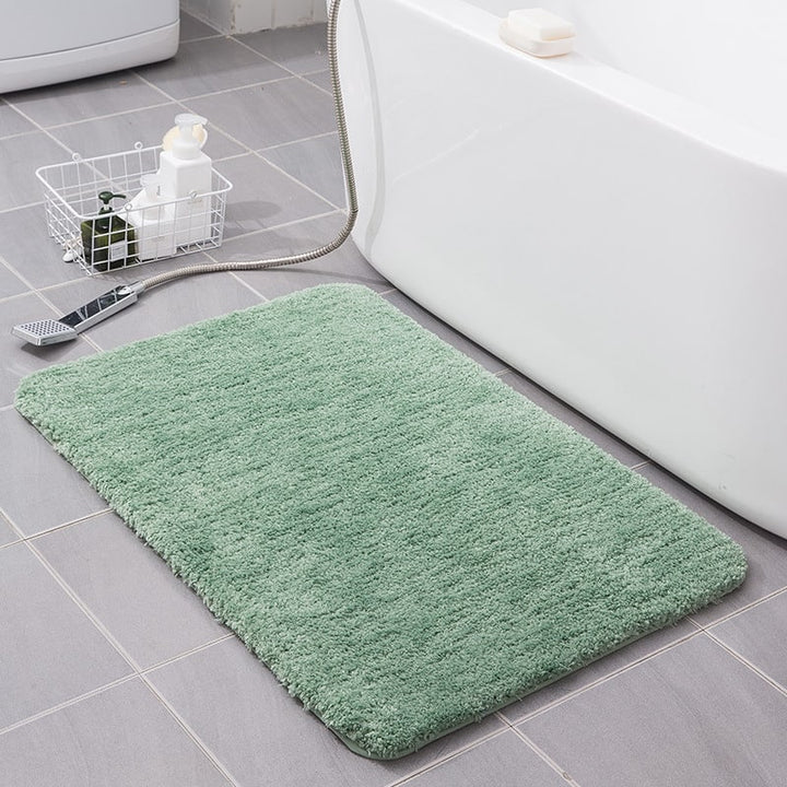 Elegant shaggy bath mat, quick-dry microfiber, non-slip base, enhances bathroom home decor.
