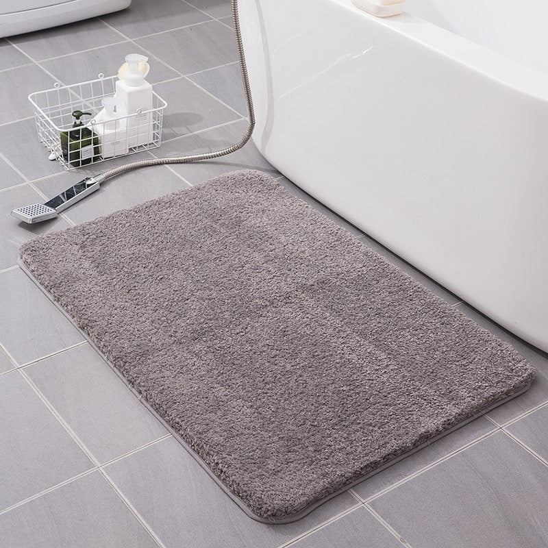 Plush rectangular bath mat with absorbent shaggy microfiber, perfect for shower exits.