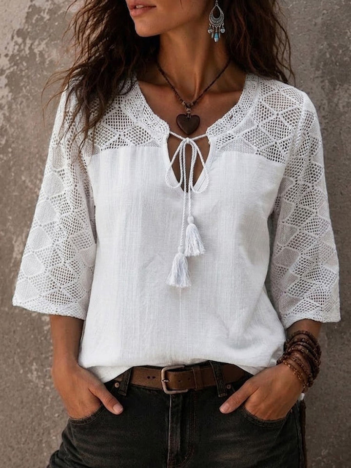 Stylish women's boho V-neck tunic top with crochet trim and three-quarter sleeves, a comfortable and elegant summer piece.