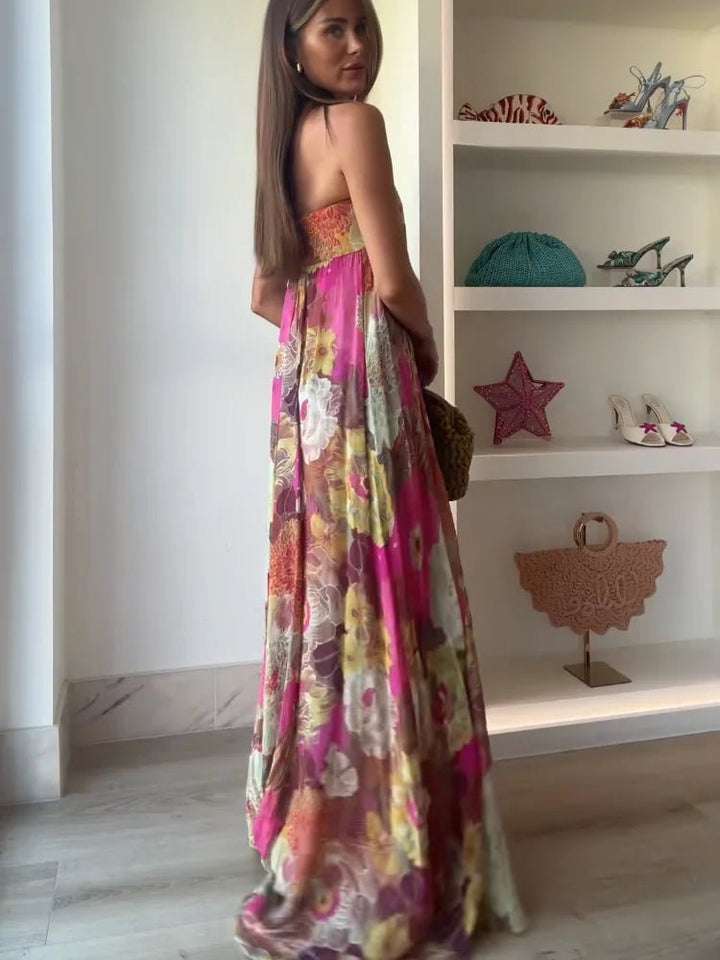 Full view of elegant women's strapless floral maxi dress, showcasing flowy silhouette and summer style.