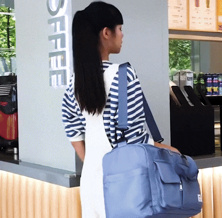Practical waterproof travel duffel for men & women, featuring a secure shoe compartment & pockets.