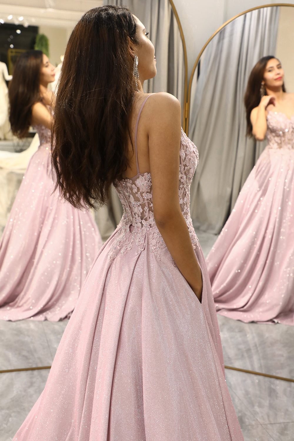 Women's sparkling blush prom or wedding guest dress. A-line evening gown with glitter details and V-neck.