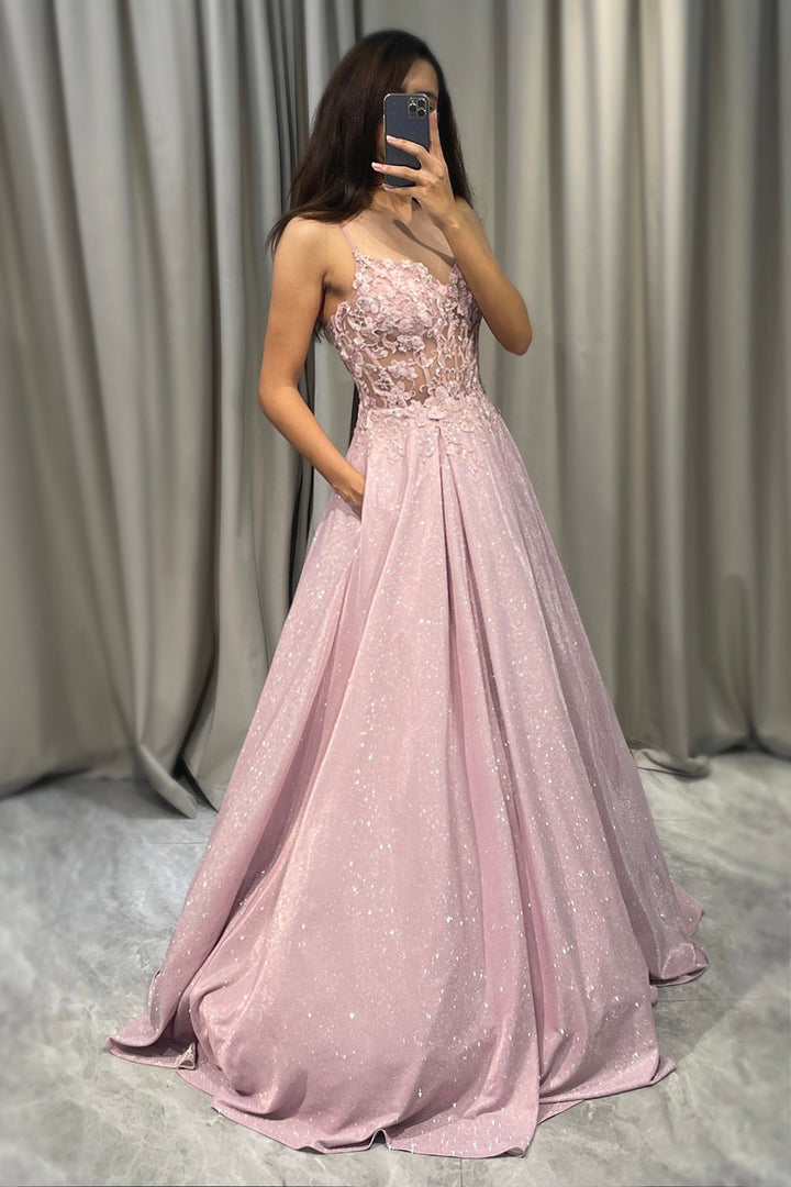 Luxurious sparkling blush pink A-line gown. Women's formal evening dress with shimmering fabric and elegant flow.
