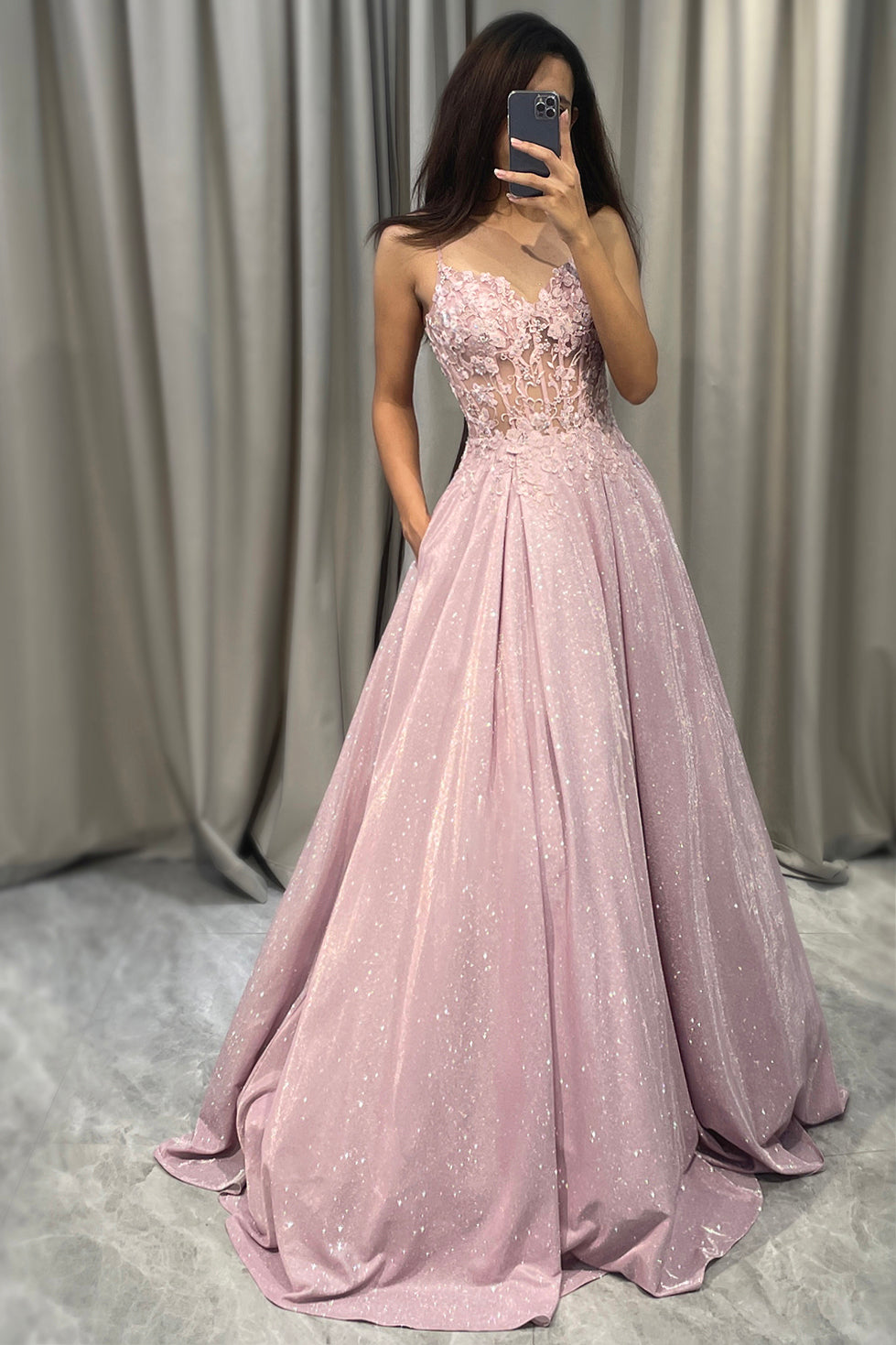 Sparkling blush A-line ball gown for women. Elegant floor-length formal dress with V-neck & spaghetti straps.