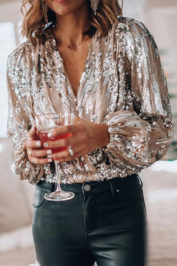 Elegant women's glitter V-neck top with long sleeves. Shimmering fabric perfect for a festive outfit.