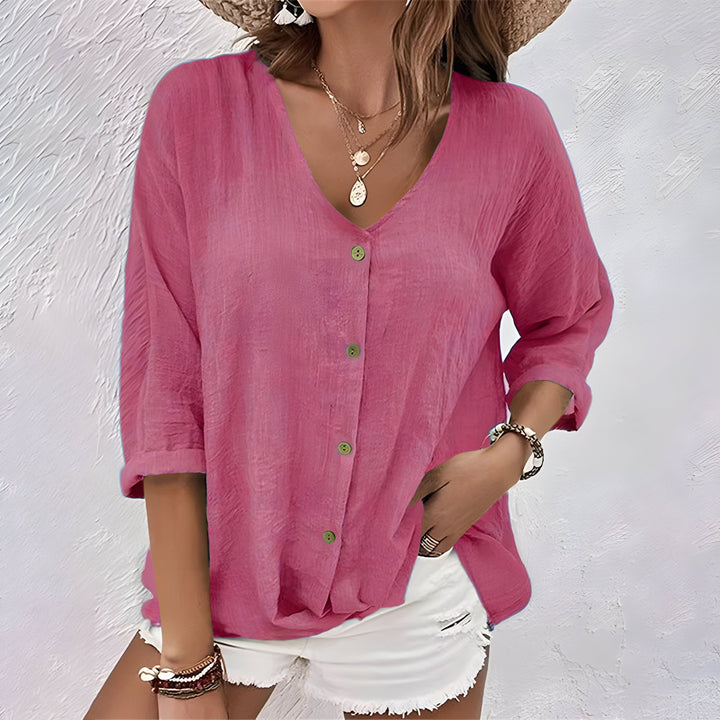 Versatile women's button-up blouse with V-neck & roll sleeves. A comfortable, stylish top for casual and summer outfits.