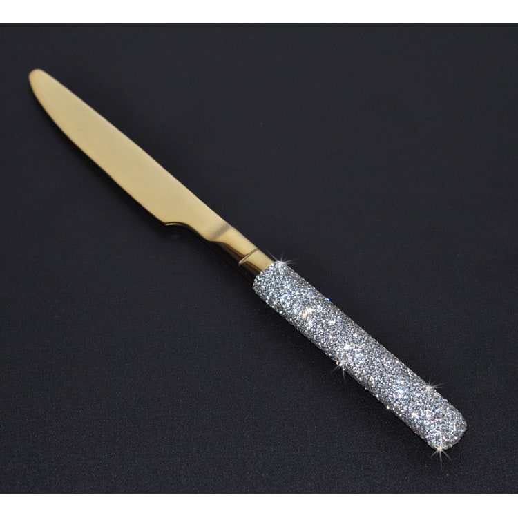 Full view of a 20-piece elegant gold & silver flatware set, each utensil featuring decorative rhinestone handles.