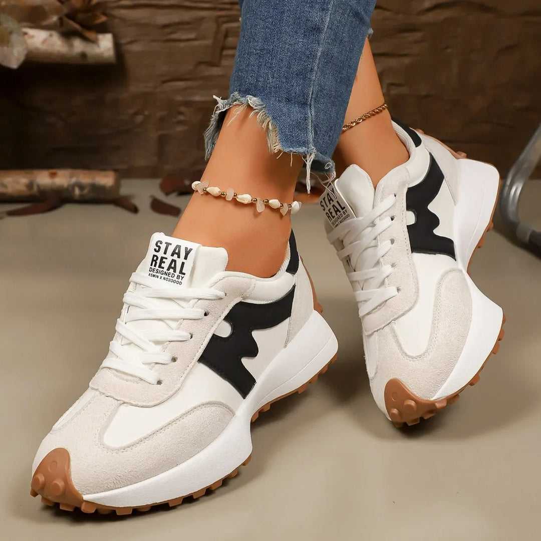 Modern striped platform sneakers, lace-up, offering elevated style for women.