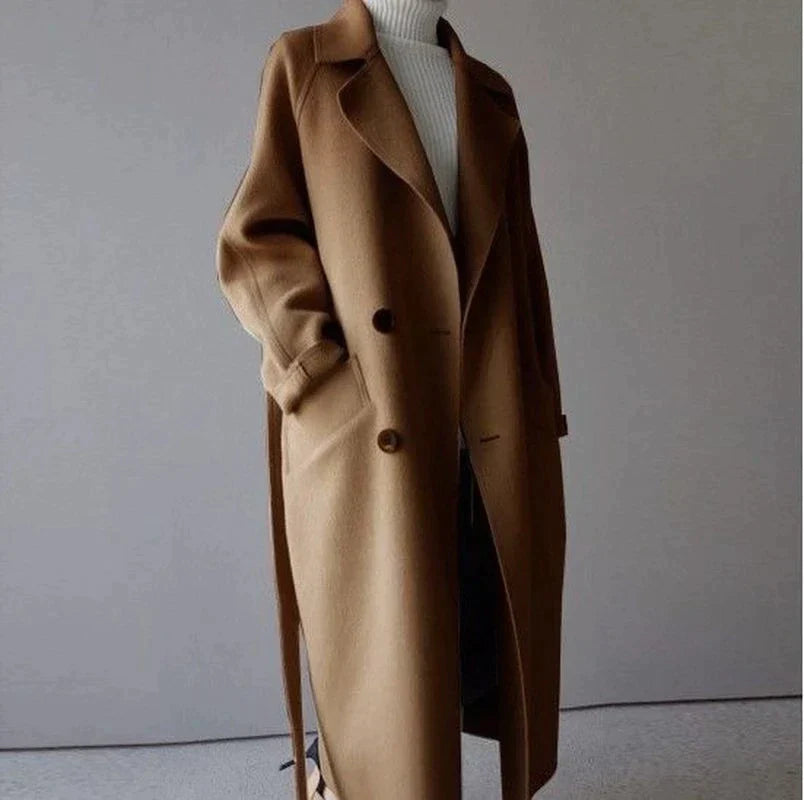Chic beige women's warm winter coat. Long, elegant outerwear for fall fashion, suitable for office and casual looks.