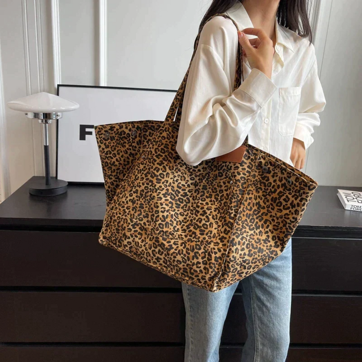 Trendy animal print handbag, a must-have women's fashion accessory with a vibrant leopard pattern.