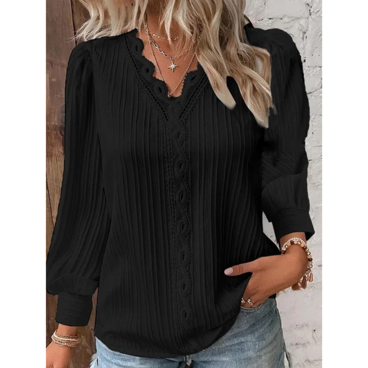 Modern women's V-neck long sleeve top. Stylish and comfortable, ideal for versatile office and casual apparel.
