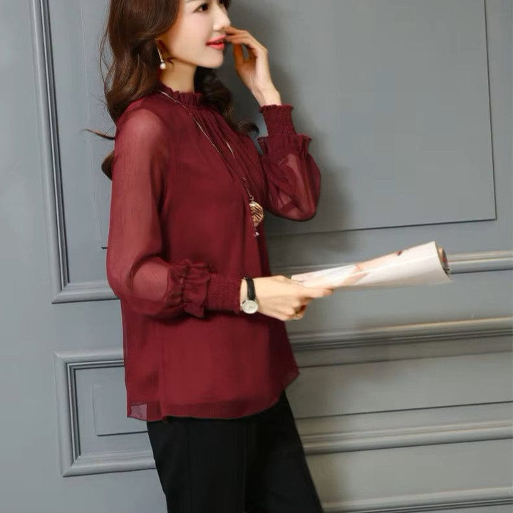 Stylish women's chiffon blouse featuring delicate ruffles & transparent puff sleeves. Casual or elegant.