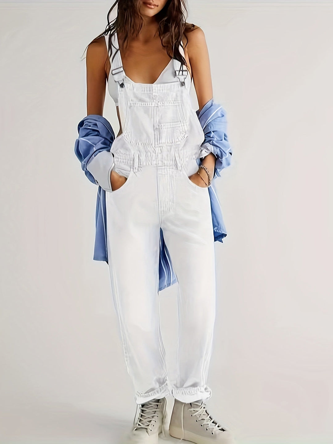 Comfortable loose-fit women's denim jumpsuit for casual everyday fashion and versatile styling.