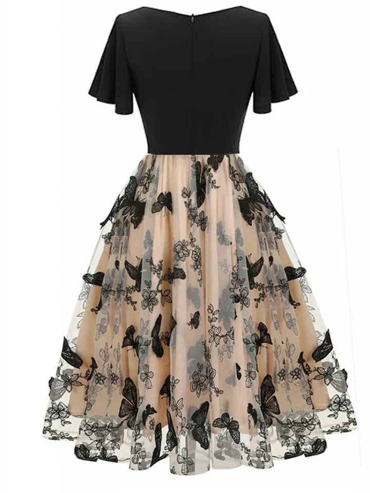 Women's elegant short-sleeve A-line midi dress, beautifully embroidered with colorful butterflies on a dark fabric.
