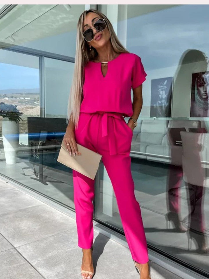 Elegant women's wide leg jumpsuit with a chic V-neck, perfect for versatile evening wear or summer events.