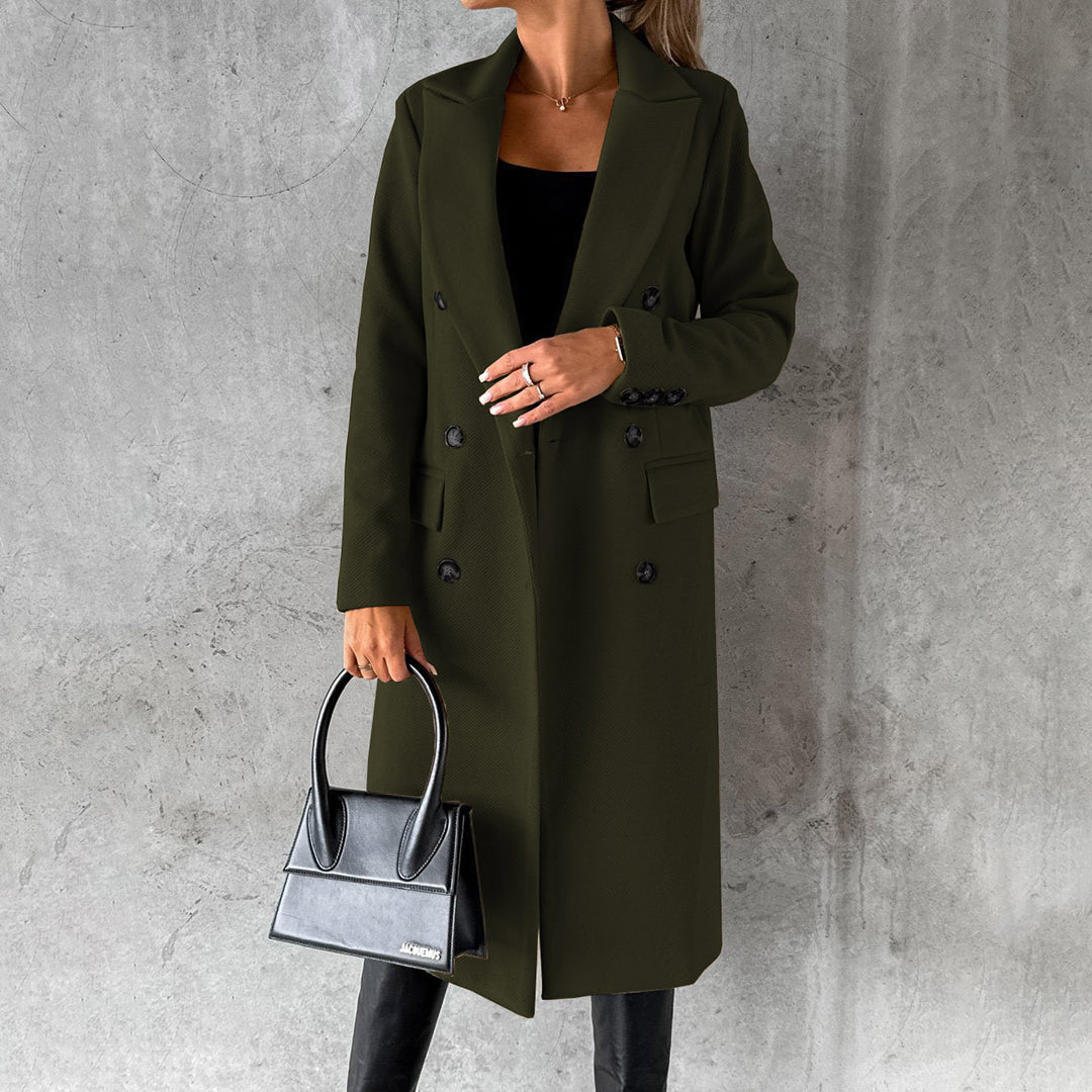 Woman wearing a chic Elara long winter coat, staying warm & stylish. Elegant outerwear for cold weather.