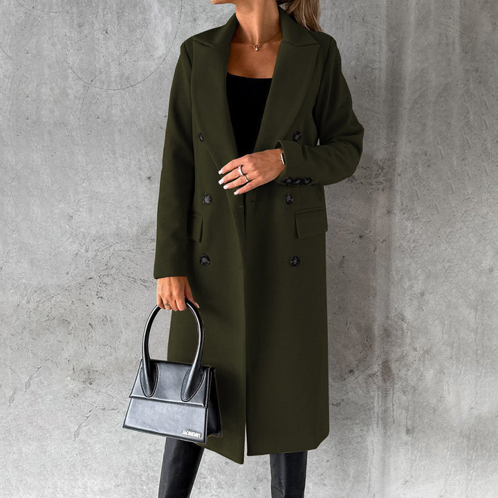 Woman wearing a chic Elara long winter coat, staying warm & stylish. Elegant outerwear for cold weather.