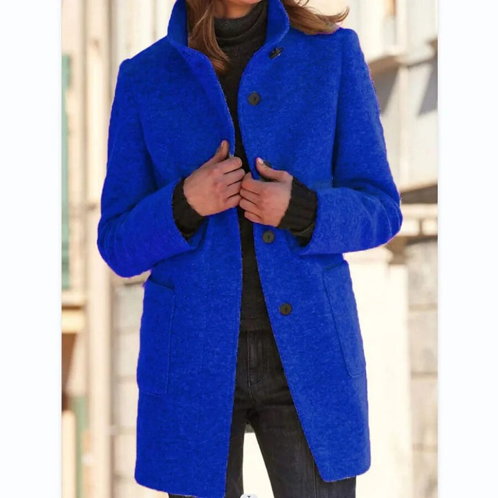 Stylish women's long winter coat featuring a classic buttoned front & elegant standing collar. Warm outerwear.