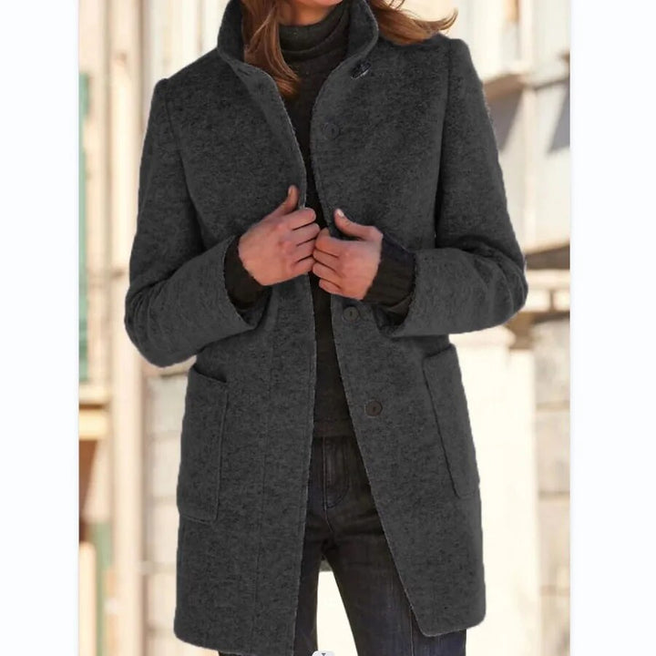Women's classic buttoned winter coat, warm overcoat. Stylish long outerwear with elegant standing collar.